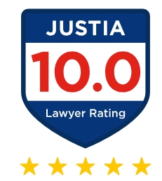 A blue shield-shaped badge with "JUSTIA 10.0 Lawyer Rating" written on it, and five gold stars below, indicating a top lawyer rating. A blue shield-shaped badge with "JUSTIA 10.0 Lawyer Rating" written on it, and five gold stars below, indicating a top lawyer rating.