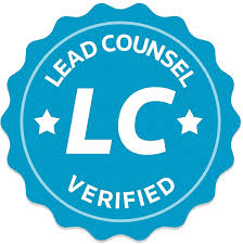 A blue circular badge with a scalloped edge. In white text, it reads "LEAD COUNSEL VERIFIED" with "LC" in large letters in the center, flanked by two stars. A blue circular badge with a scalloped edge. In white text, it reads "LEAD COUNSEL VERIFIED" with "LC" in large letters in the center, flanked by two stars.