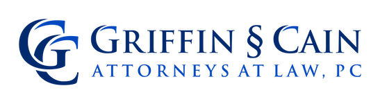 Logo for Griffin & Cain Attorneys at Law, PC, featuring stylized overlapping letters "G" and "C" in blue, with the firm name and title written in blue capital letters to the right.